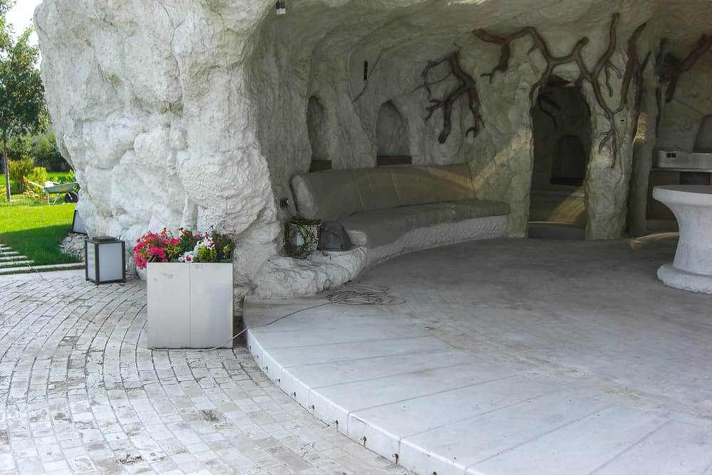 Man-made grotto as sunshade and architectural highlight in landscape design.